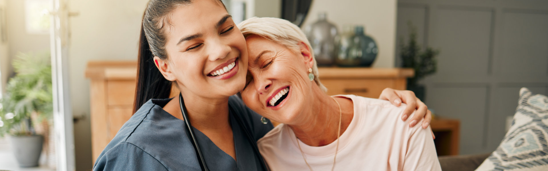 caregiver hugging the elderly